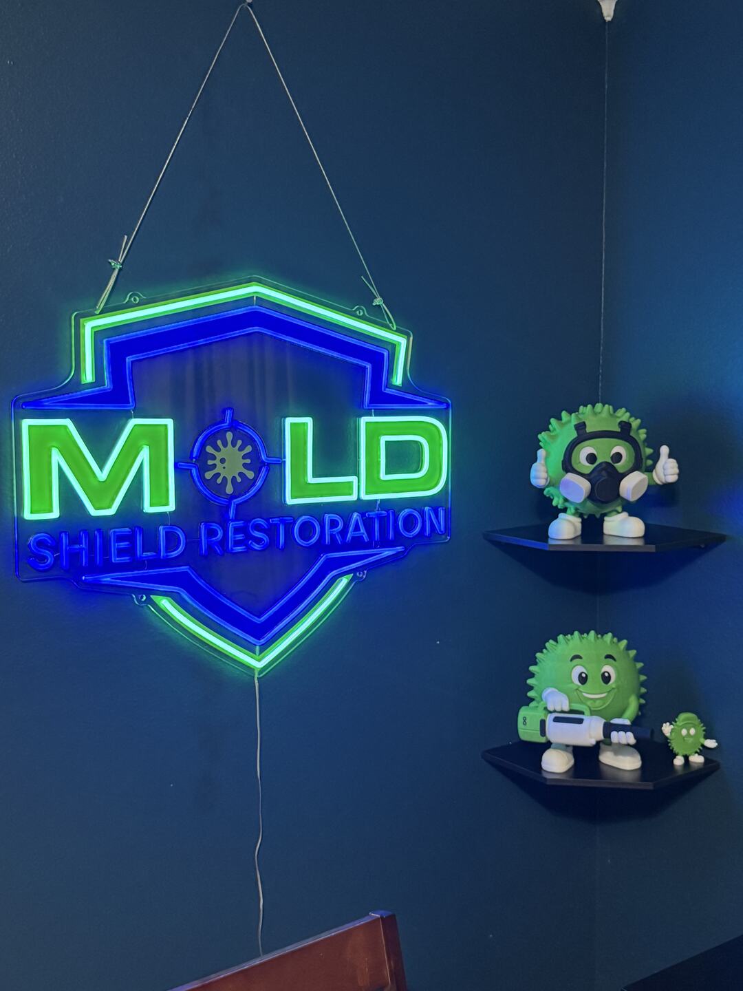 The Mold Shield Restoration sign that appears behind Ron in the company videos